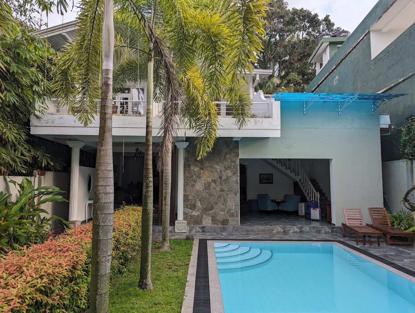 Deltora Villa exterior — two-storey villa building with pool and palm trees, Galle
