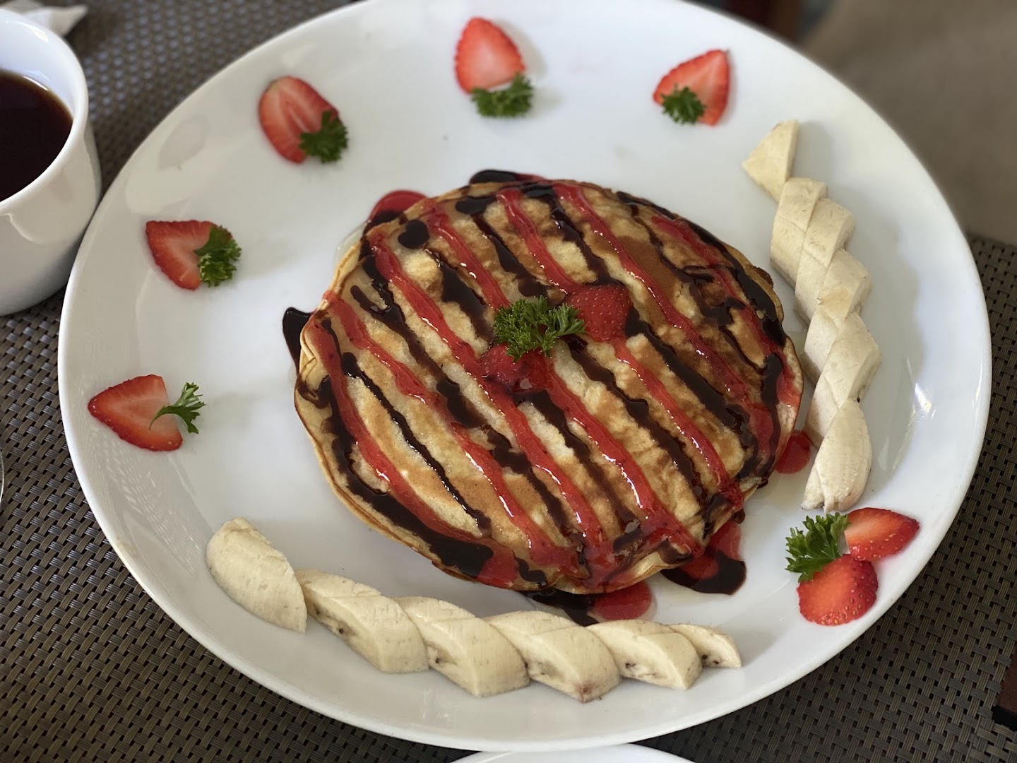 Deltora Villa breakfast — freshly made waffle with chocolate and strawberries