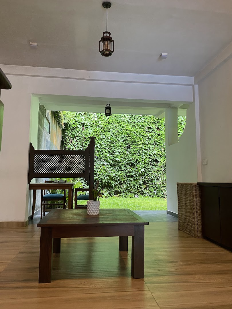 Deltora Villa open-air lounge with pendant lanterns and tropical garden view