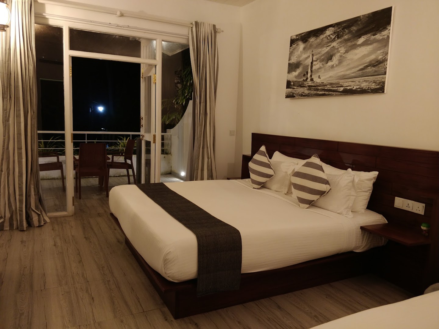 Deltora Villa guest bedroom with nautical wall art and comfortable king bed